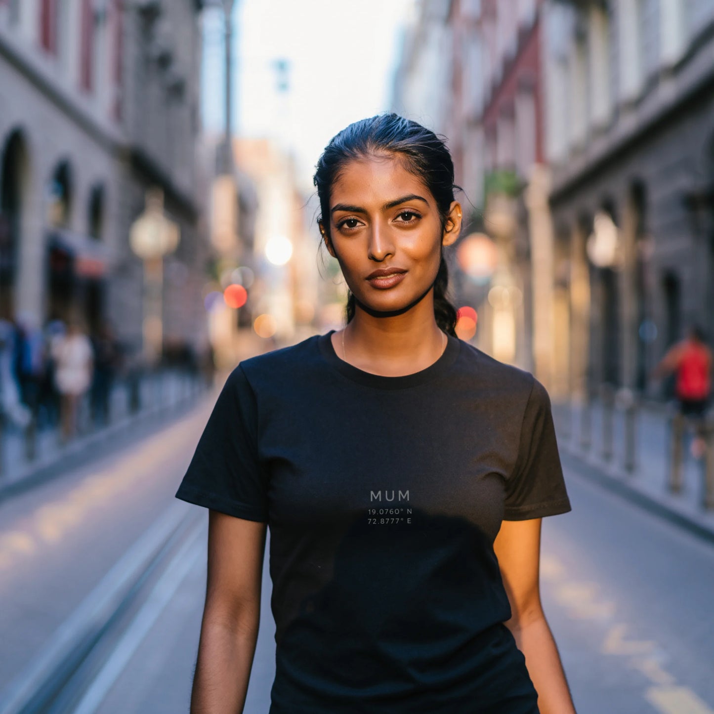 Black women’s luxury Supima cotton t-shirt featuring subtle text design, premium soft fabric in modern lifestyle setting