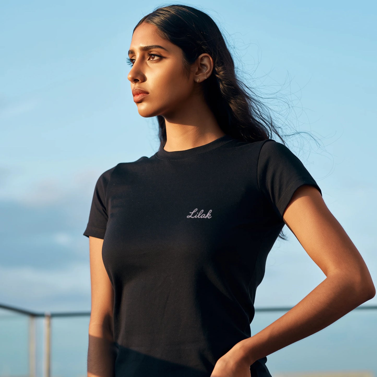 Black women’s premium Supima cotton t-shirt featuring subtle “Lilak” logo, modern minimalist streetwear style