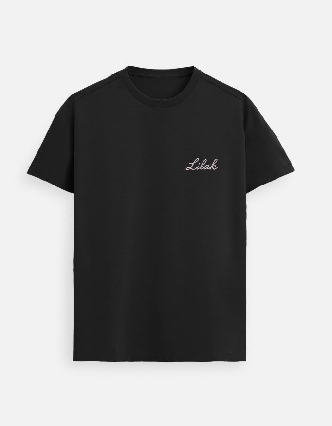 Black women’s premium Supima cotton t-shirt featuring subtle “Lilak” logo, modern minimalist streetwear style