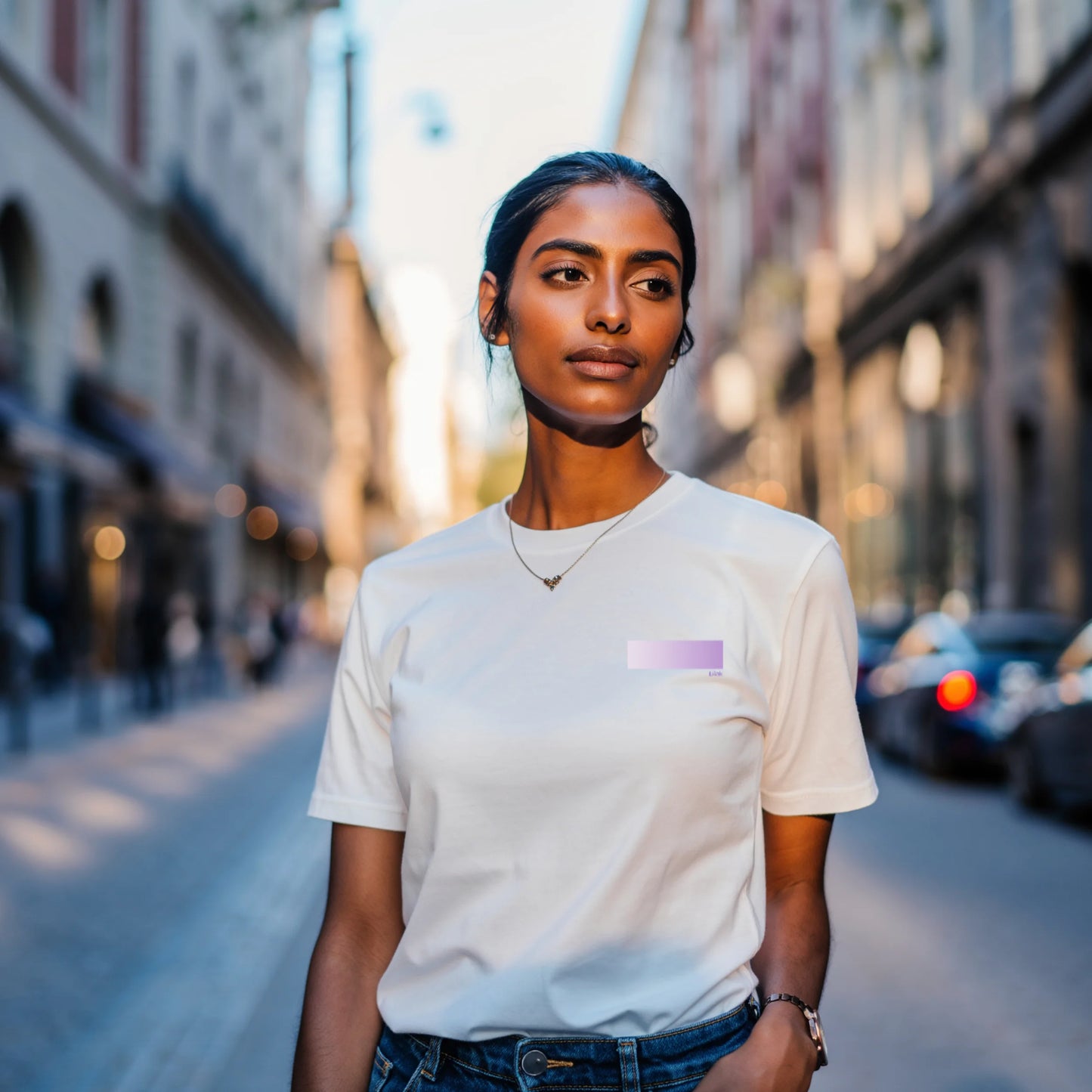 Woman wearing a premium supima cotton white t-shirt with a colorful square design on a city street.